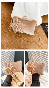 Detail of champagne velvet clutch with 3D feather flower and diamond-set ring clasp