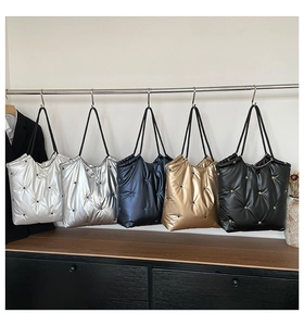 Quilted tote bags display in five metallic colors with star embroidery details