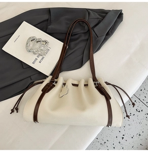 Detail shot of the cream leather texture and contrasting brown drawstring closure