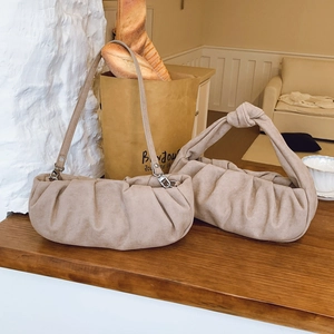 Elegant beige ruched cloud bags in handbag and crossbody styles with soft suede texture