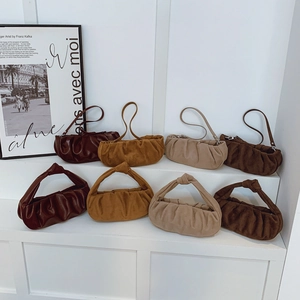 Chic pleated cloud bags collection in earthy tones displayed on a minimalist background