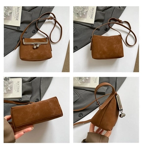 Detail view of vintage brown crossbody bag with metal clasp and matte leather texture