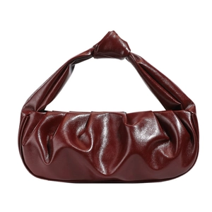 Elegant wine red pleated cloud bag with glossy finish and knotted handle in a minimalist style