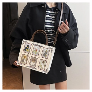 Detail of artistic cat tarot cards print and brown leather handles on small tote bag