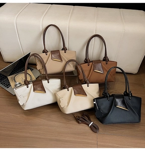 Detailed collection of textured pleated handbags in five colors with laptop background