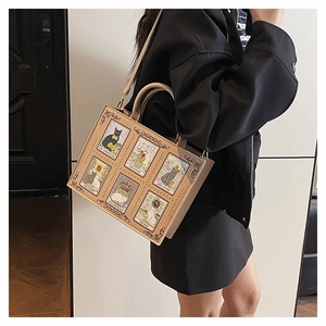 Detail of beige tote bag featuring vintage cat tarot card prints and rivet decorations