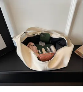 Interior view of large white shoulder bag showing spacious storage for daily essentials