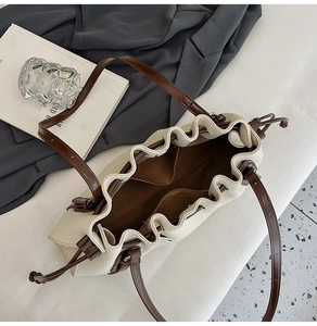 Top-down view of the cream tote bag interior featuring dark brown lining and inner pocket