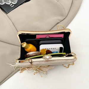Interior view showing the large capacity of a beige velvet evening bag with gold chain