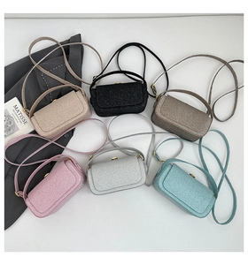 Top view of compact crossbody box bags in six colors with metallic flip clasp detail