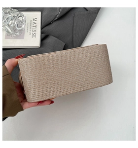 Detail of champagne gold woven small square handbag with metallic texture and sleek design