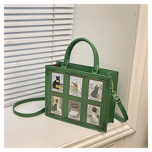 Detailed view of the green tote bag featuring six unique cat tarot card illustrations