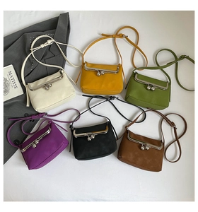 Macro shot of vintage metal clasps and textured leather on colorful crossbody bags