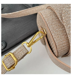 Detailed macro view of champagne gold glitter bag with elegant gold metal twist lock