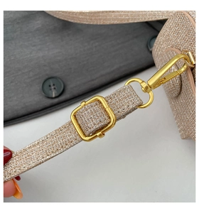 Macro shot of champagne gold glitter strap with adjustable metallic golden buckle hardware
