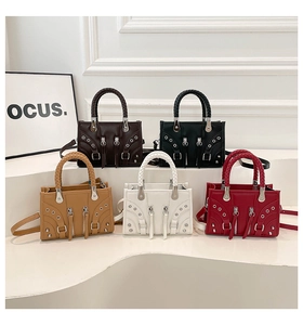 Five assorted colors of vintage biker style crossbody bags with stud details