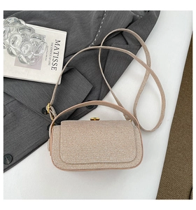 Detail of champagne gold box bag showing metallic texture and golden metal lock