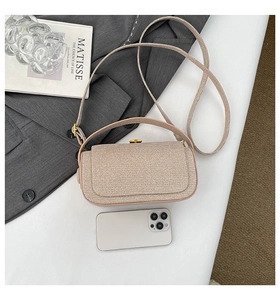 Close-up of beige woven texture mini box bag with gold twist lock and stylish top handle
