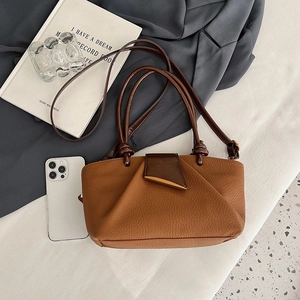 Minimalist brown lychee leather handbag with gold triangle clasp and dual shoulder straps