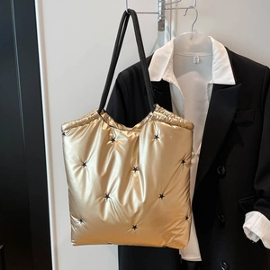 Golden quilted space cotton tote bag with black star embroidery and slim shoulder straps
