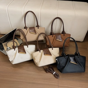 Minimalist pleated leather handbags with gold trim in white, cream, and black colors