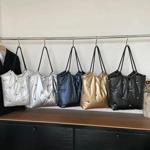Quilted puffer tote bags with star studs in silver, navy, gold, and black colors