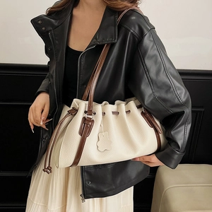 Chic cream white pleated shoulder bag with brown leather straps and drawstring closure