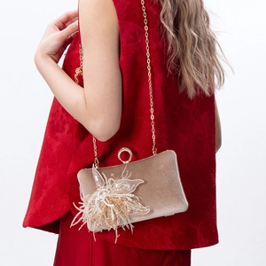Elegant gold velvet evening clutch bag with pearl floral detail and chain strap