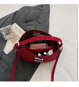 Top view of red handbag interior showing large capacity and zipper compartments