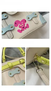 Detailed view of the mini box bag showing the blue bow, pink rabbit print, and stitching