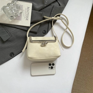 Retro beige leather crossbody shell bag with silver clasp and adjustable shoulder strap
