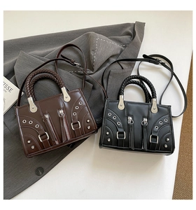 Detail of vintage motorcycle style handbags with woven handles and silver rivets
