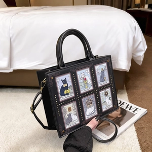 Black tote bag featuring cat tarot card illustrations and gold stud embellishments