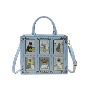 Light blue faux leather tote bag featuring artistic tarot cat prints and crossbody strap