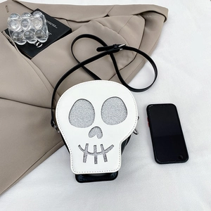 Skull shaped crossbody bag in black and white with silver glitter details and strap