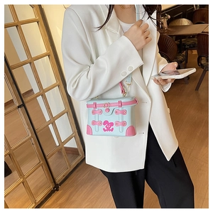 Close-up of mini box bag with pink rabbit pattern and golden metal buckle clasp