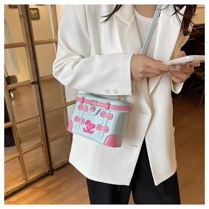 Detail of light blue box bag with pink leather trim and cartoon bunny print