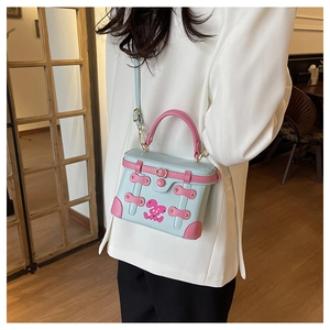 Close-up of the mini contrast box bag in light blue and pink with a cute rabbit design
