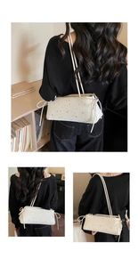 Detail of cream white sequin hobo bag featuring star patterns and drawstring ties