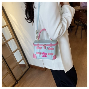 Detailed view of a mini contrast color box bag with cute rabbit and metallic studs