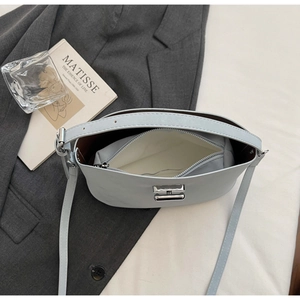 Overhead view showing large capacity interior and white inner pouch of the blue leather bag