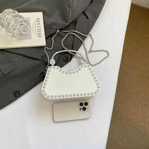 White rivet box handbag with silver chain and curved metal handle for evening parties