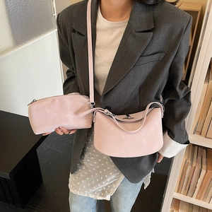 Pink dumpling bag two-piece set featuring a large shoulder bag and small zipper pouch