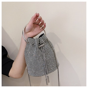 Detailed view of silver rhinestone bucket bag with metal ring handle and chain strap