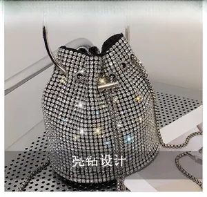 Macro detail of silver bucket bag showing intricate rhinestone mesh and drawstring