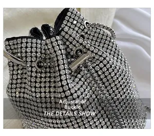 Detail of rhinestone bucket bag with adjustable metal buckle and shiny chain drawstring