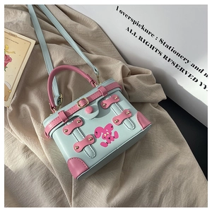 Detail of a vintage box bag with pink rabbit print and contrasting leather finish