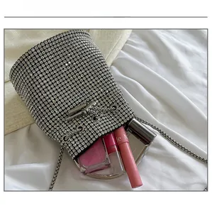 Silver rhinestone bucket bag interior showing capacity for lipstick and makeup items