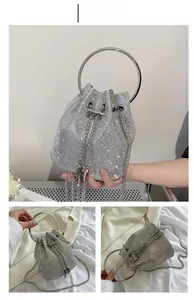 Detailed macro view of the silver rhinestone bucket bag with metal chain strap