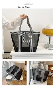Large black mesh tote bag with striped straps and bow detail for beach and daily travel